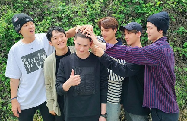 EXO members come together to support Suho as he enlists in military